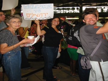 Ginny, Elana, and Larry welcoming the new student arrivals at Ben Gurion Airport -- August 12th, 2002